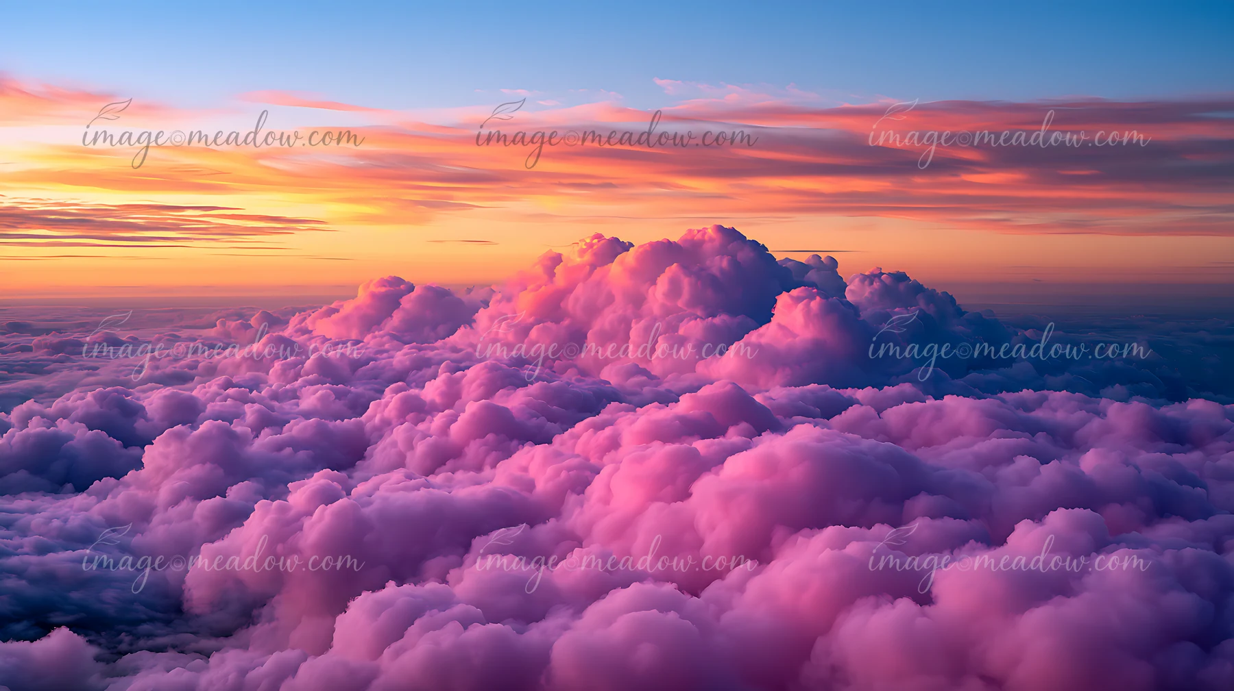 The sky is filled with fluffy clouds that show shades of pink and orange during sunset.