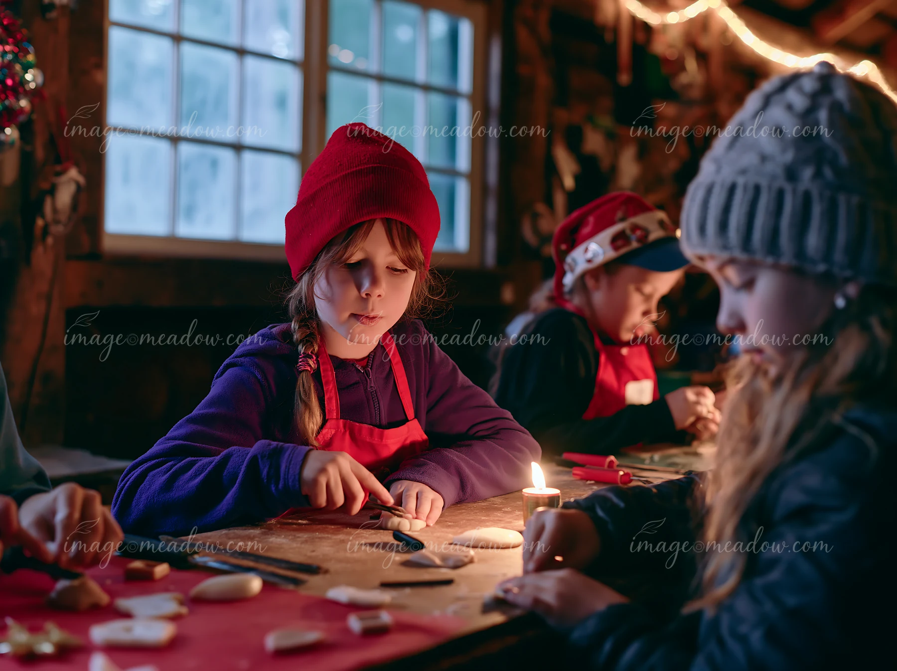 Three children make handmade ornaments at a warmly lit holiday craft table.