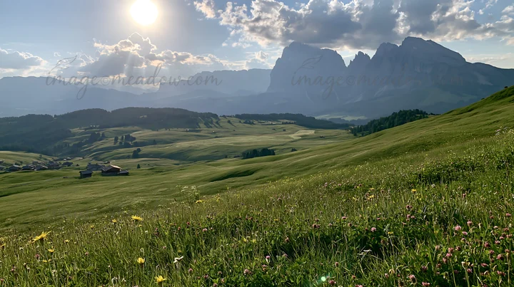 Sunbeams shine over the lush Alpe di Siusi meadow. Green grass covers the area, and distant mountains rise sharply against a cloudy sky. This scene captures the