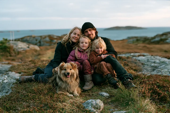 A family enjoys time together outdoors with a rare dog breed family with dog.