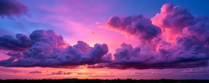 A sunset displays colorful clouds in shades of purple and pink, casting a glow over the landscape.