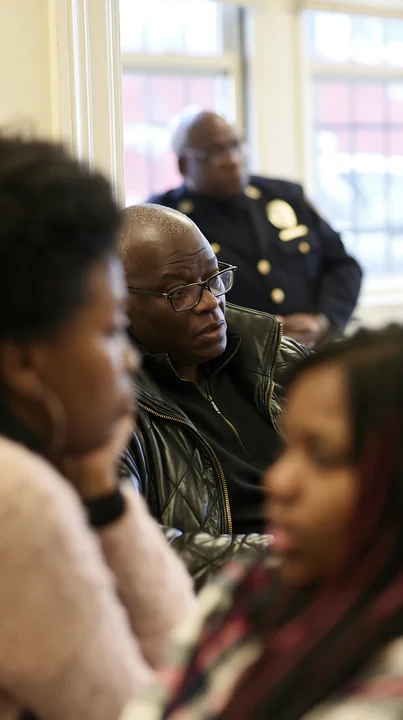 A police chief listens intently during a civilian oversight meeting.