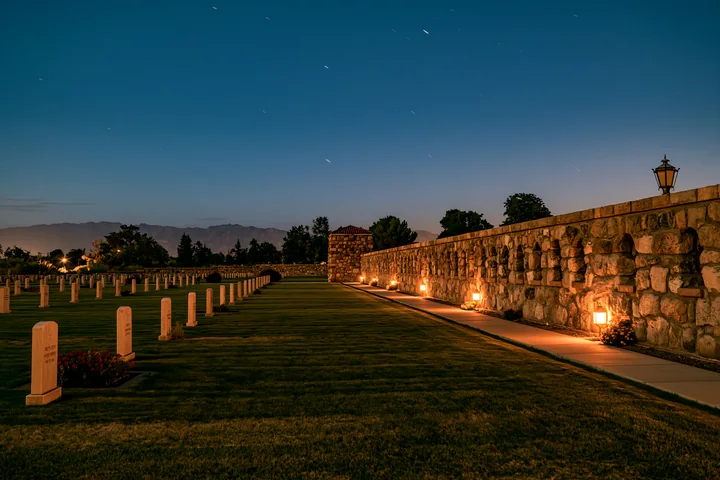 A soldiers' cemetery is seen under a starry sky filled with shooting stars.