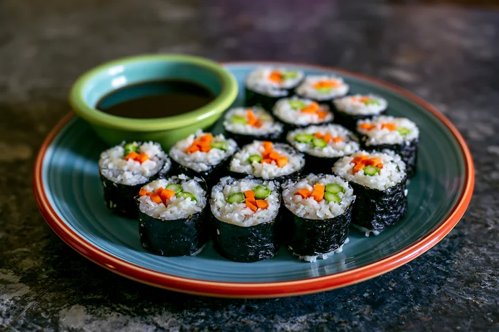 A vegan sushi platter features different rolls with vegetables.